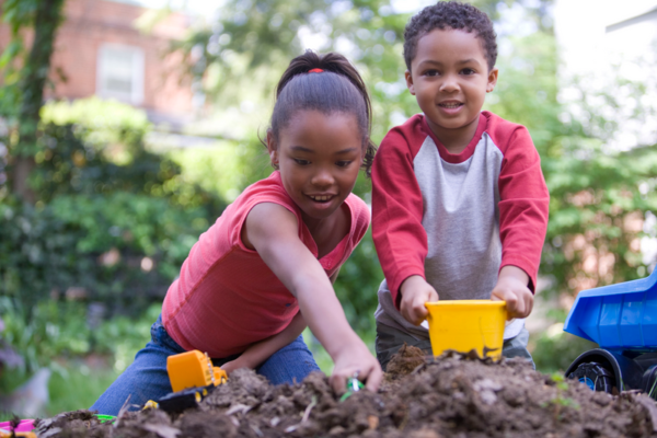 Children playing outside while working at home with kids